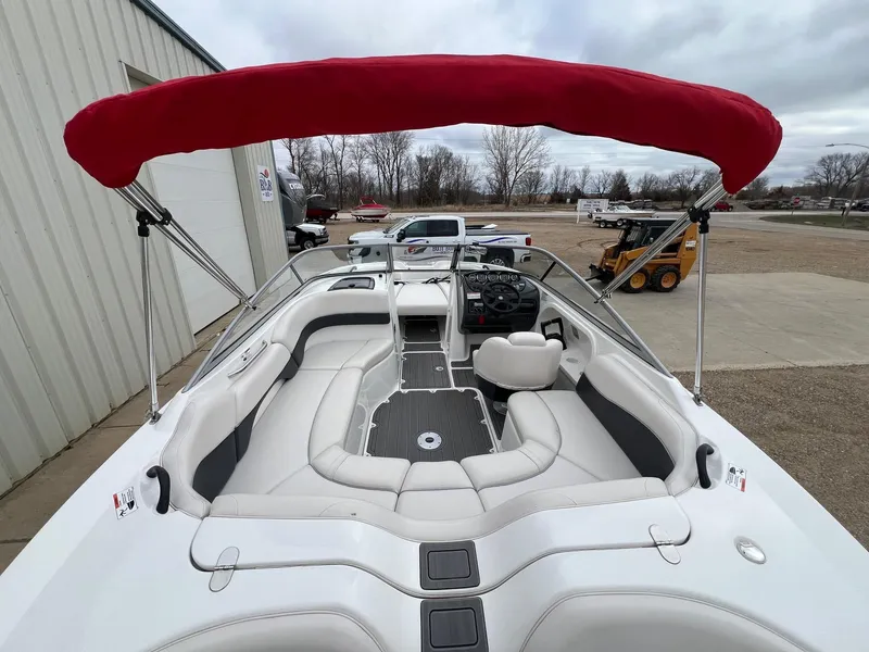 Slide: The Image of 2007 Yamaha Boats SX210 with red canopy, white seating, and modern dashboard. - 9