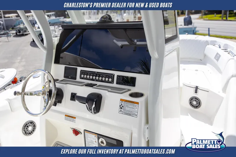 Slide: The Image of 2025 Sea Fox 228 Commander boat dashboard with steering wheel and controls. - 11