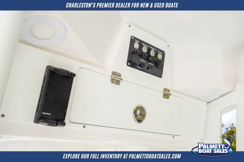 Slide: The Image of 2025 Sea Fox 228 Commander dashboard with control panel and storage compartment. - 20