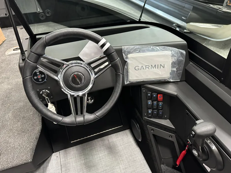 Slide: The Image of 2025 Alumacraft Competitor 185X Sport dashboard with Garmin navigation system and steering wheel. - 12