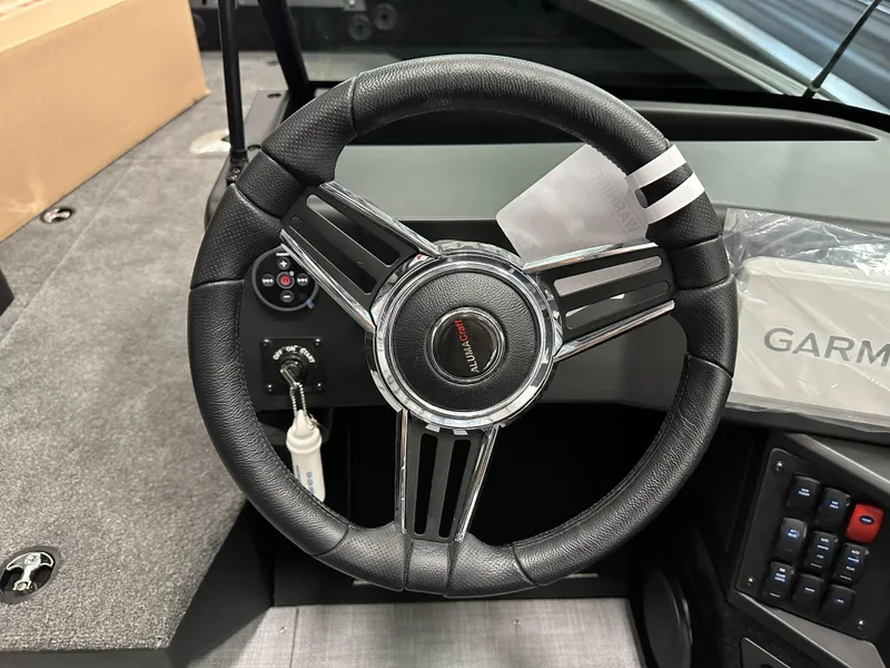Slide: The Image of 2025 Alumacraft Competitor 185X Sport steering wheel and dashboard with Garmin system. - 13