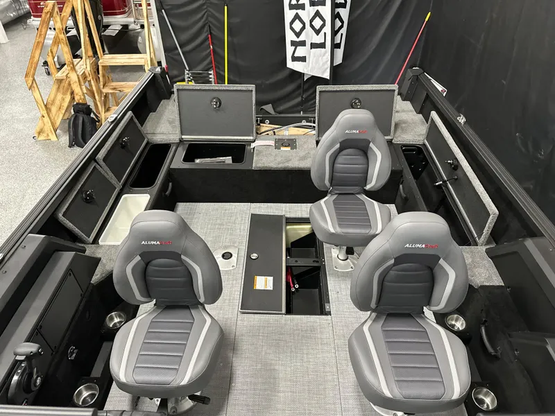 Slide: The Image of 2025 Alumacraft Competitor 185X Sport interior with four seats and storage compartments. - 16