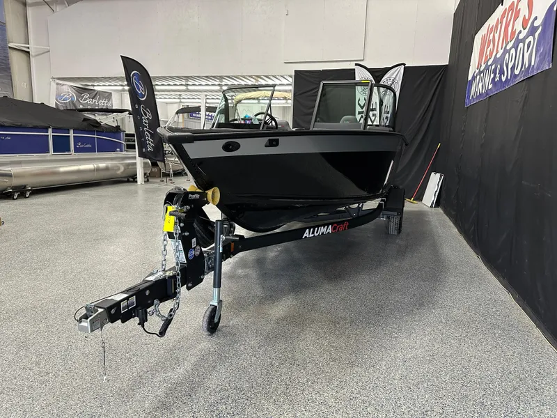 Slide: The Image of 2025 Alumacraft Competitor 185X Sport boat displayed at Westre's Marine & Sport showroom. - 4