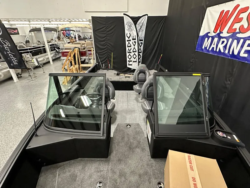 Slide: The Image of 2025 Alumacraft Competitor 185X Sport boat interior at a marine showroom display. - 7