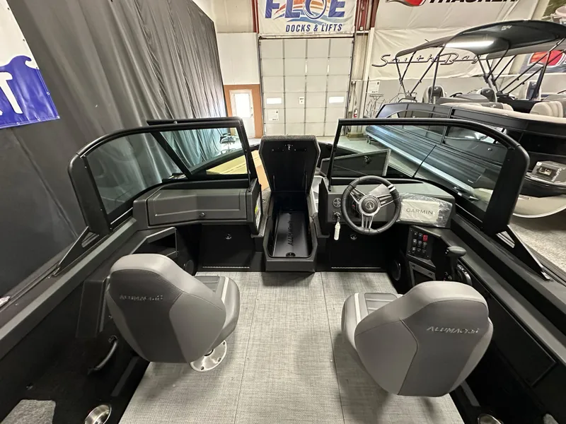 Slide: The Image of 2025 Alumacraft Competitor 185X Sport boat interior with dual seats and modern dashboard. - 9