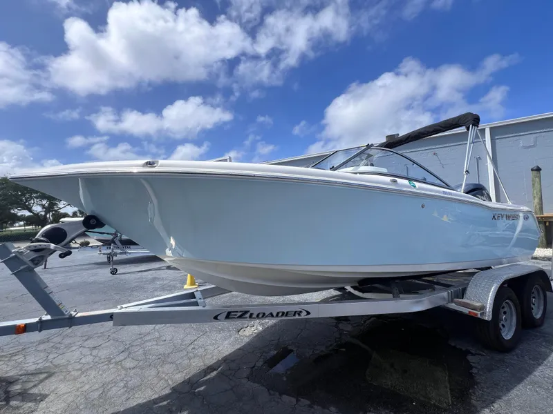 Slide: The Image of 2025 Key West 203 DFS boat on trailer under blue sky. - 1