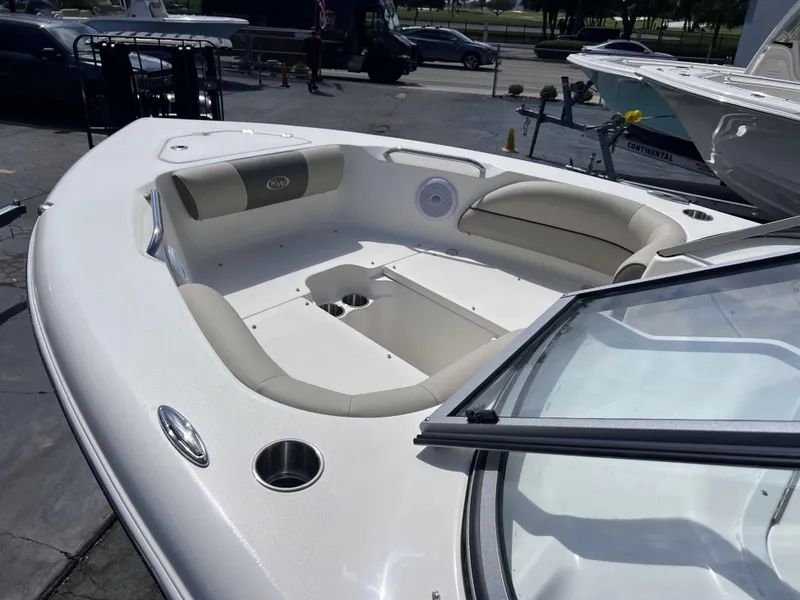 Slide: The Image of 2025 Key West 203 DFS boat interior with beige seating and cup holders. - 11