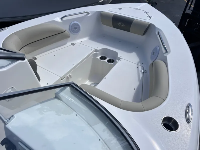 Slide: The Image of 2025 Key West 203 DFS boat interior with cushioned seating and cup holders. - 12
