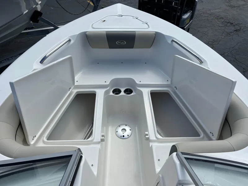 Slide: The Image of 2025 Key West 203 DFS boat interior with open storage compartments and cup holders. - 13