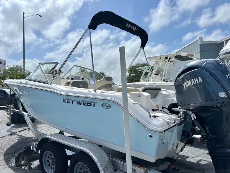 Slide: The Image of 2025 Key West 203 DFS boat on trailer with Yamaha engine, under clear sky. - 2