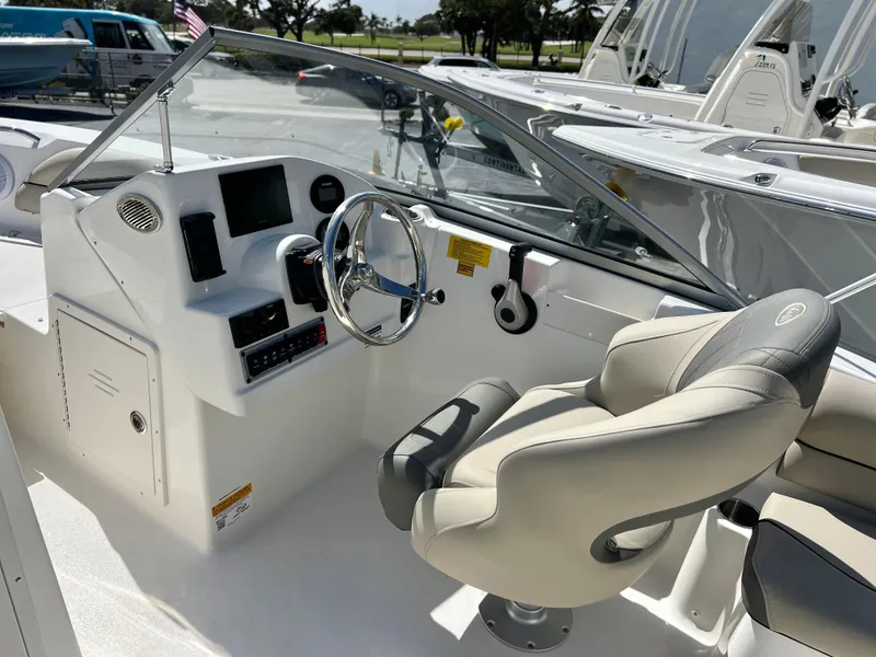 Slide: The Image of 2025 Key West 203 DFS boat interior with steering wheel and control panel. - 20