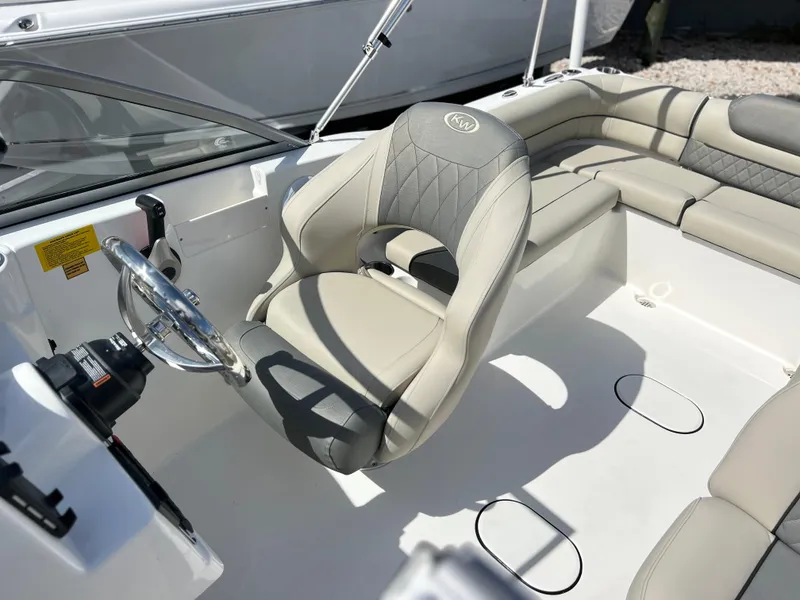 Slide: The Image of 2025 Key West 203 DFS boat interior with steering wheel and cushioned seating. - 22