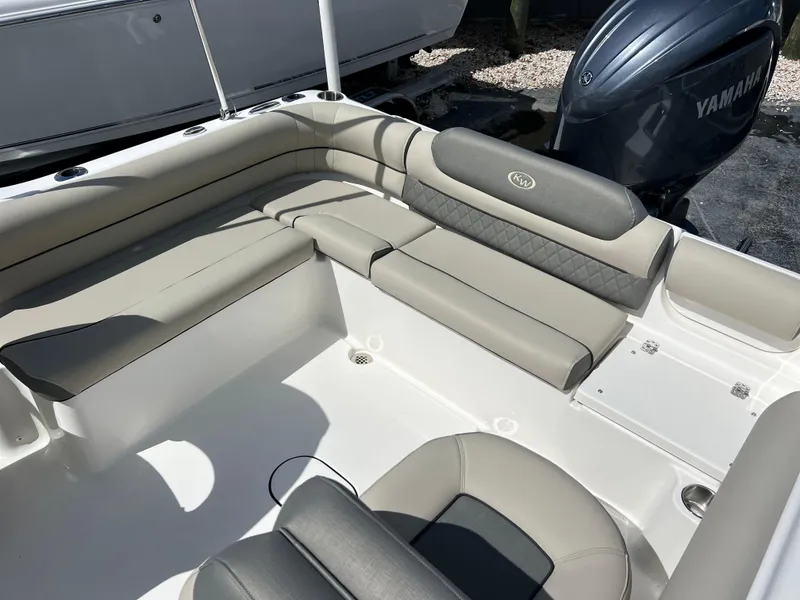 Slide: The Image of 2025 Key West 203 DFS boat interior with beige seating and Yamaha engine. - 24