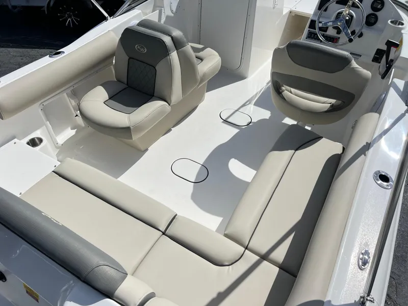 Slide: The Image of 2025 Key West 203 DFS boat interior with beige seating and steering console. - 25