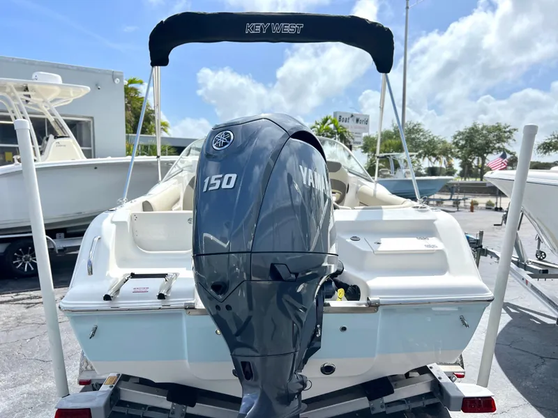 Slide: The Image of 2025 Key West 203 DFS boat with Yamaha 150 engine, parked outdoors. - 3