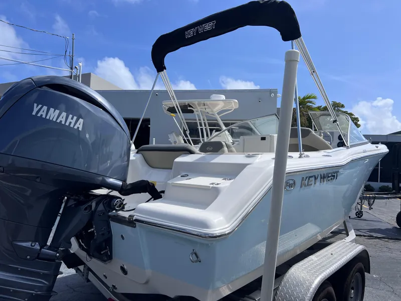 Slide: The Image of 2025 Key West 203 DFS boat with Yamaha engine on trailer, under clear blue sky. - 4
