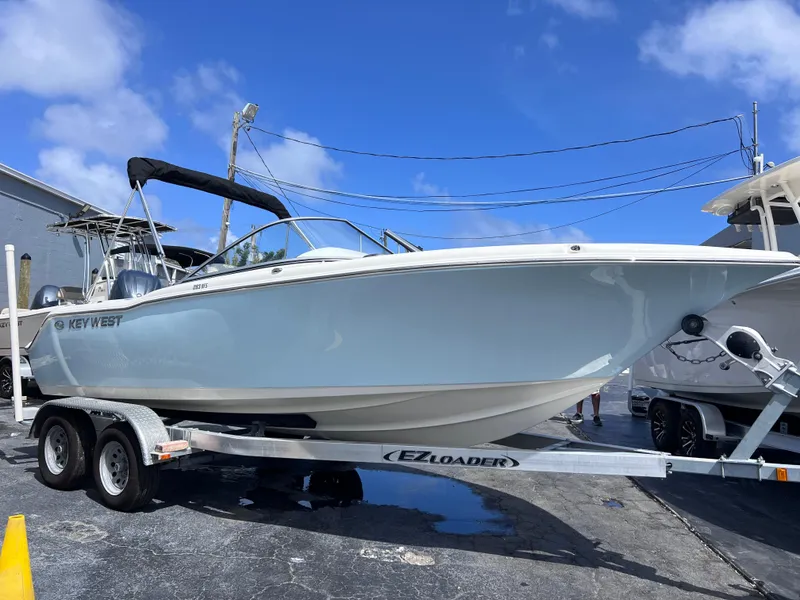 Slide: The Image of 2025 Key West 203 DFS boat on trailer under clear blue sky. - 7