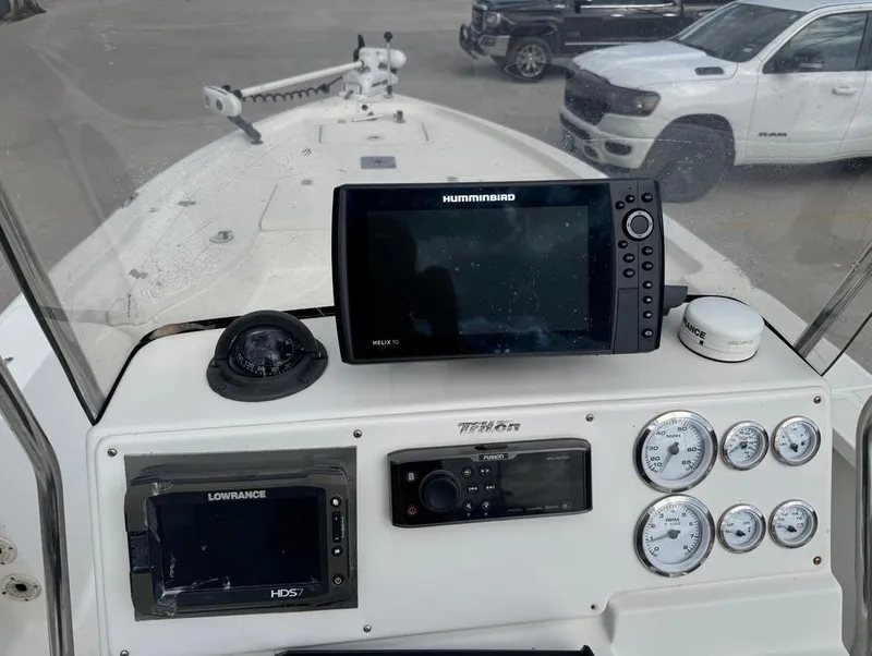 Slide: The Image of 2007 Triton 240 LTS boat dashboard with navigation equipment and gauges. - 10