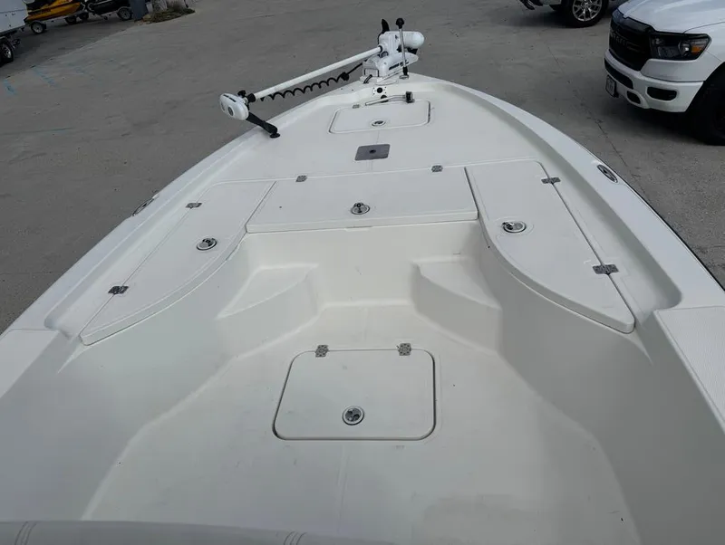 Slide: The Image of 2007 Triton 240 LTS boat deck with storage compartments and trolling motor. - 12