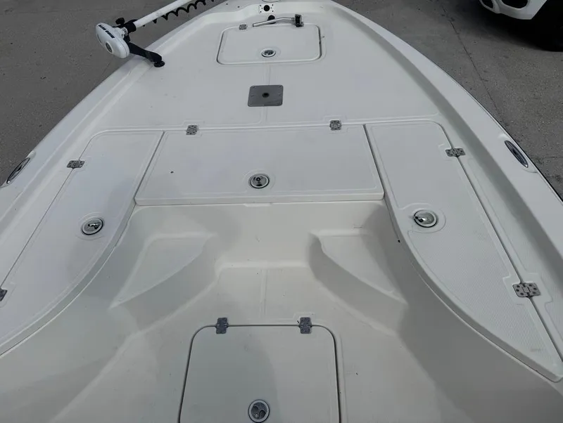 Slide: The Image of 2007 Triton 240 LTS boat deck with storage compartments and trolling motor. - 13