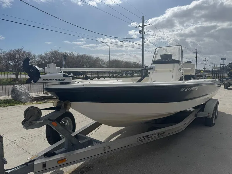 Slide: The Image of 2007 Triton 240 LTS boat on trailer under cloudy sky. - 2