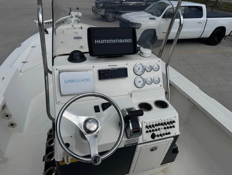 Slide: The Image of 2007 Triton 240 LTS boat console with steering wheel, gauges, and navigation equipment. - 9