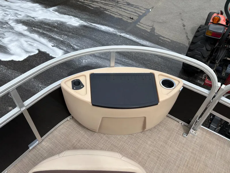 Slide: The Image of 2019 Sun Tracker Fishin Barge 24 DLX deck with seating and control panel. - 4