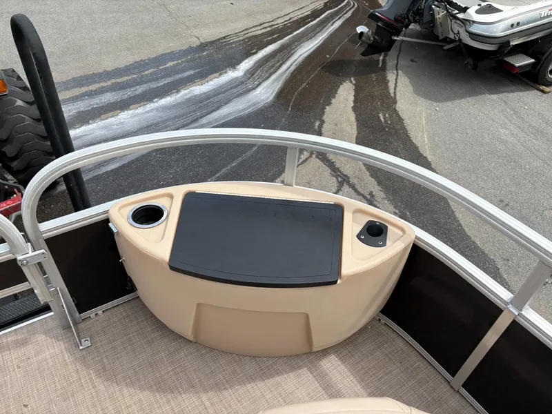 Slide: The Image of 2019 Sun Tracker Fishin Barge 24 DLX, front deck view with cup holders and storage. - 5