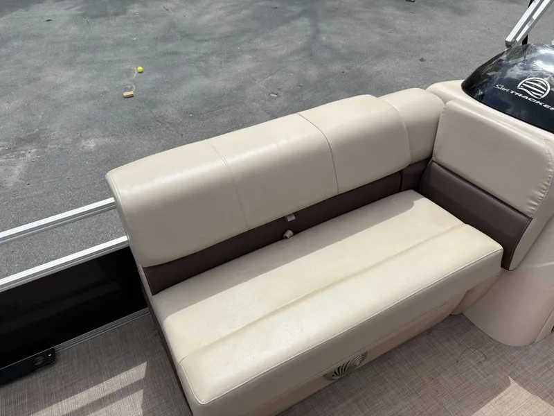 Slide: The Image of 2019 Sun Tracker Fishin Barge 24 DLX beige seating on a pontoon boat. - 7