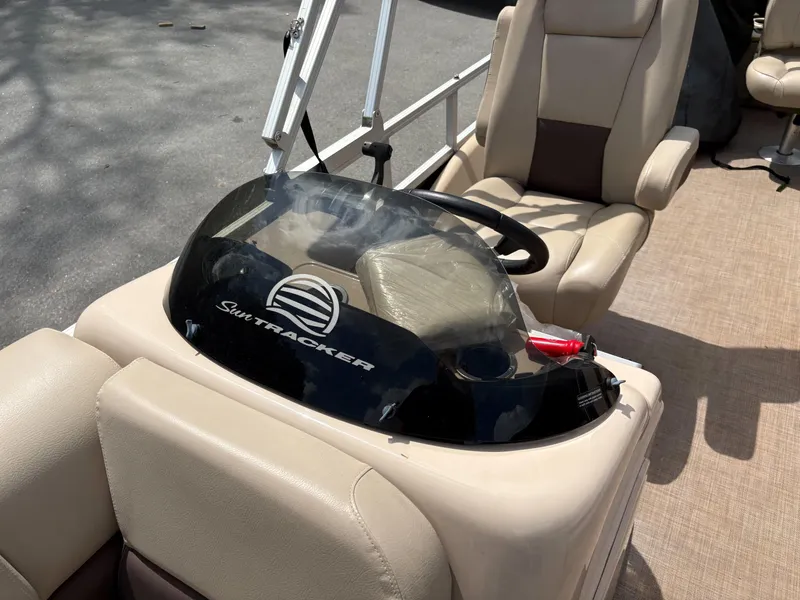 Slide: The Image of 2019 Sun Tracker Fishin Barge 24 DLX helm with steering wheel and seating. - 8
