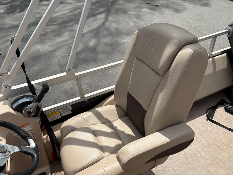Slide: The Image of 2019 Sun Tracker Fishin Barge 24 DLX captain's chair and steering console. - 9