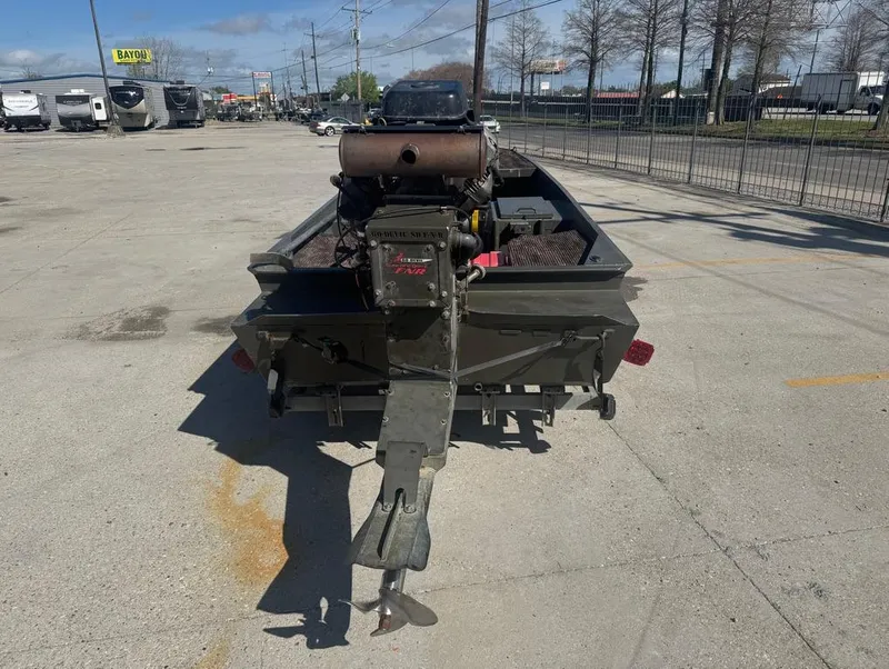 Slide: The Image of 2018 Go-Devil 18x48 Surface Drive Boat parked in a lot, rear view. - 8