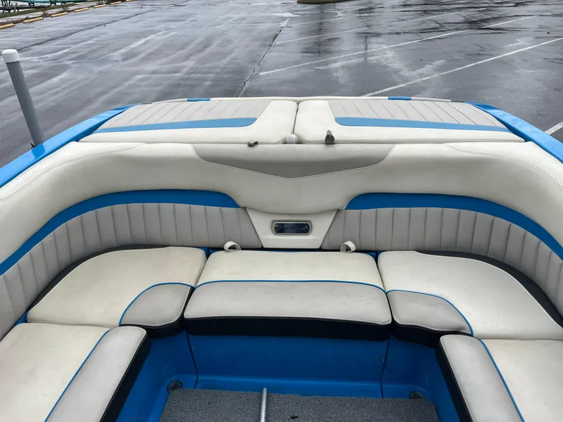 Slide: The Image of 2014 Malibu Wakesetter 24 MXZ boat interior with white and blue seating. - 3