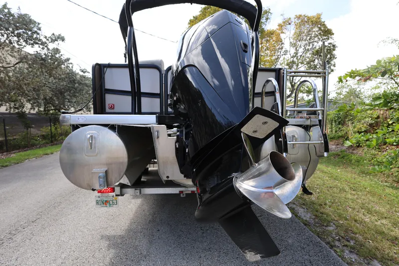 Slide: The Image of 2023 Premier 250 SunSation RF pontoon boat with powerful outboard motor on a trailer. - 5