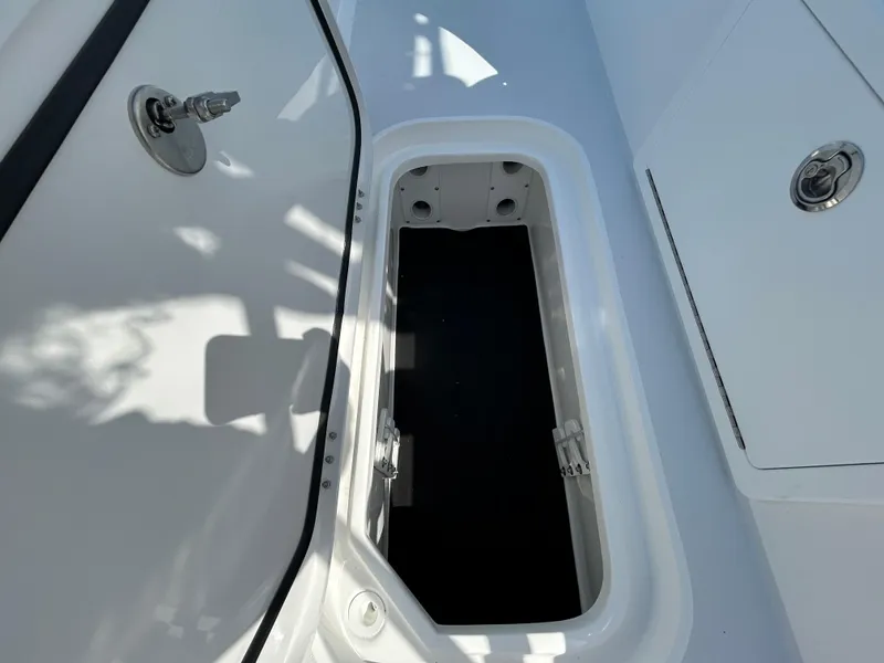 Slide: The Image of Open storage compartment on 2025 Shallow Sport 25 X3 boat. - 13