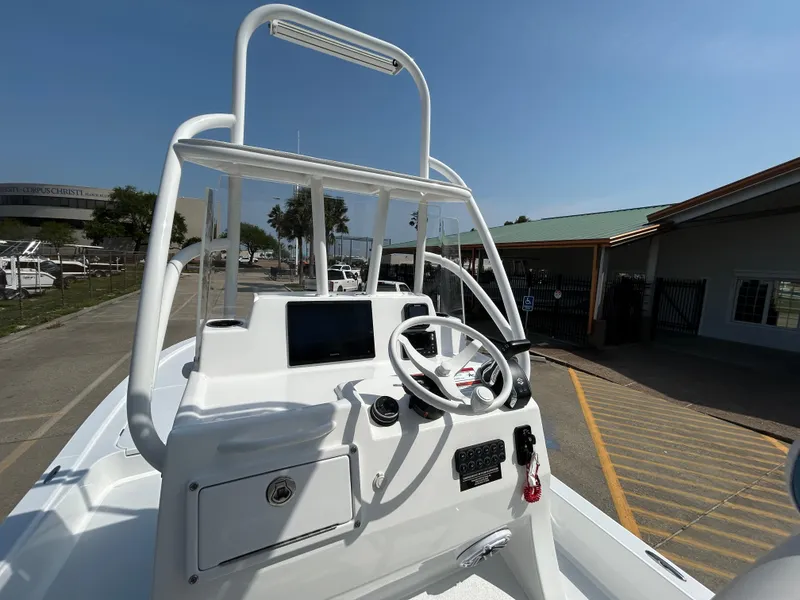 Slide: The Image of 2025 Shallow Sport 25 X3 boat console with steering wheel and navigation screen. - 15