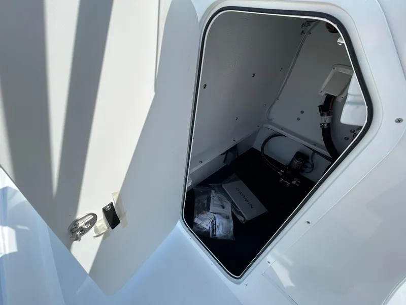 Slide: The Image of Open storage compartment in 2025 Shallow Sport 25 X3 boat. - 19
