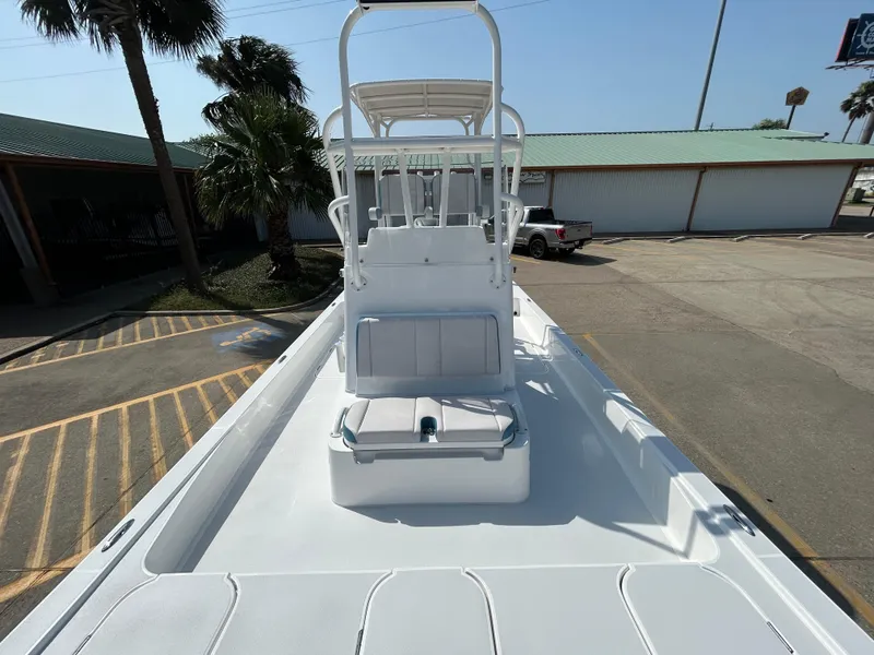 Slide: The Image of 2025 Shallow Sport 25 X3 boat with elevated helm, parked outdoors. - 22