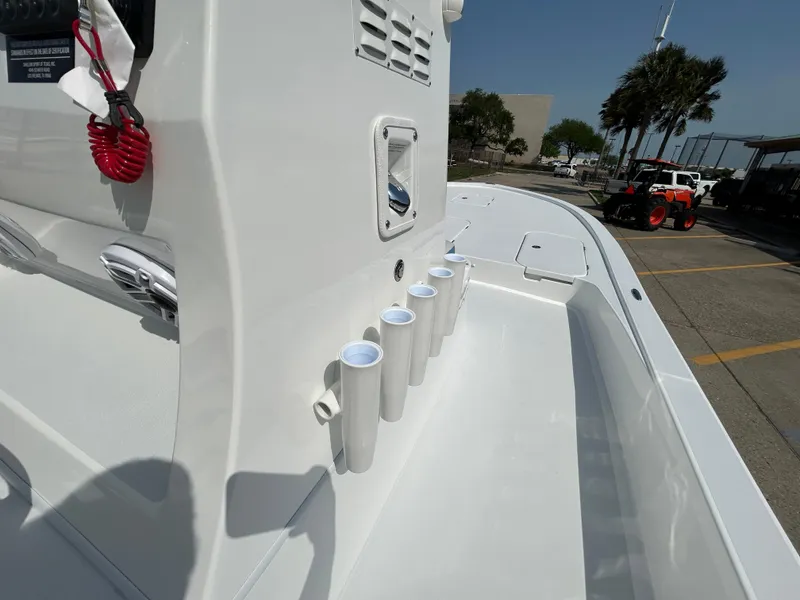 Slide: The Image of 2025 Shallow Sport 25 X3 boat interior with rod holders and console details. - 24