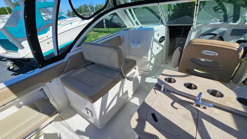 Slide: The Image of 2019 Sailfish 275 DC boat interior with seating and console, showcasing luxury and functionality. - 18