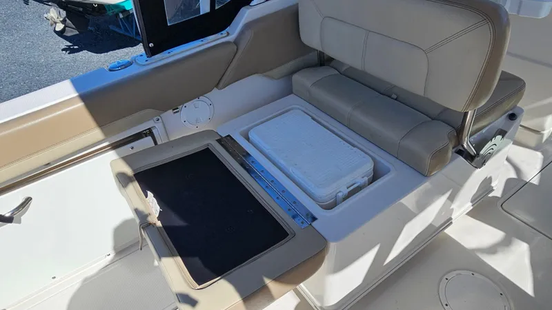 Slide: The Image of 2019 Sailfish 275 DC boat interior with seating and storage compartment. - 20