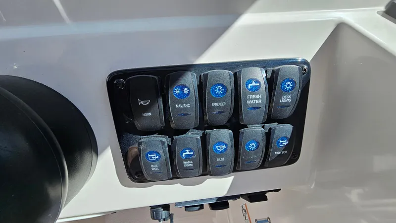 Slide: The Image of Control panel of 2019 Sailfish 275 DC boat with labeled switches. - 25