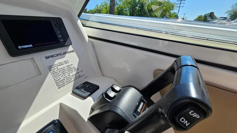 Slide: The Image of 2019 Sailfish 275 DC boat dashboard with Yamaha controls and specifications. - 26