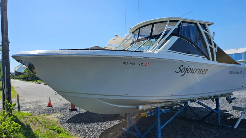 Slide: The Image of 2019 Sailfish 275 DC boat on trailer, sunny day, side view. - 3