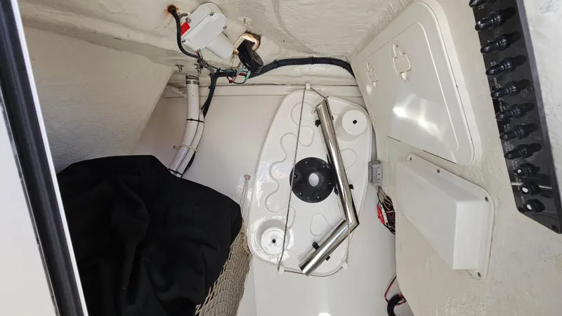 Slide: The Image of Interior view of a 2019 Sailfish 275 DC boat showing wiring and storage compartments. - 38