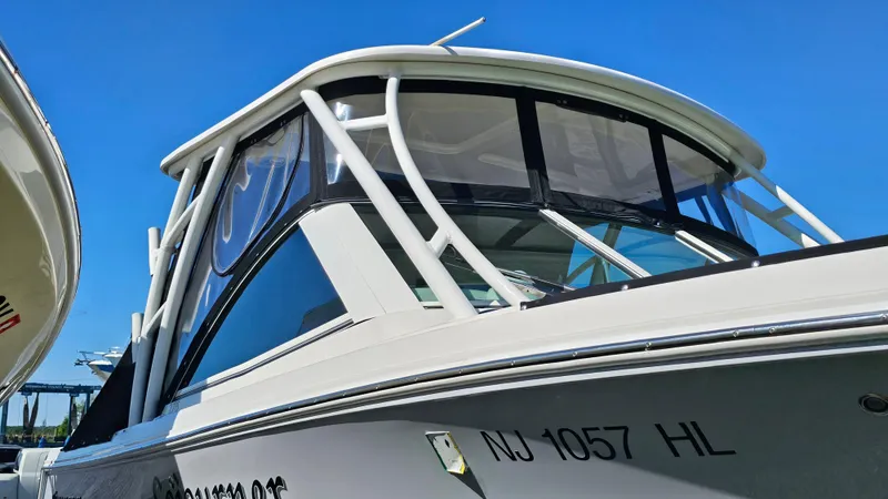 Slide: The Image of 2019 Sailfish 275 DC boat with sleek design and visible registration number. - 7