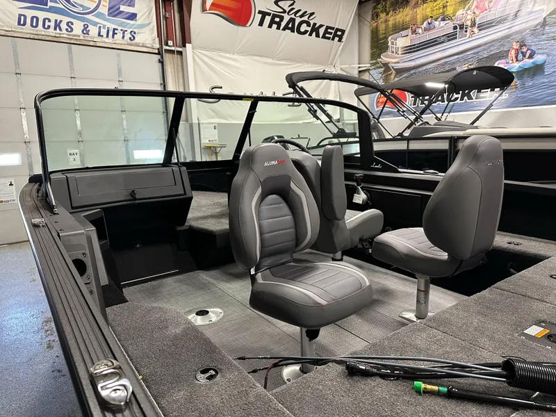 Slide: The Image of 2025 Alumacraft Competitor 175X Sport boat interior with gray seating and spacious layout. - 10
