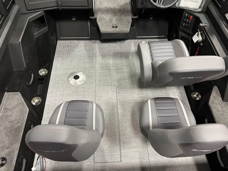 Slide: The Image of 2025 Alumacraft Competitor 175X Sport interior with gray seating and carpeted flooring. - 11