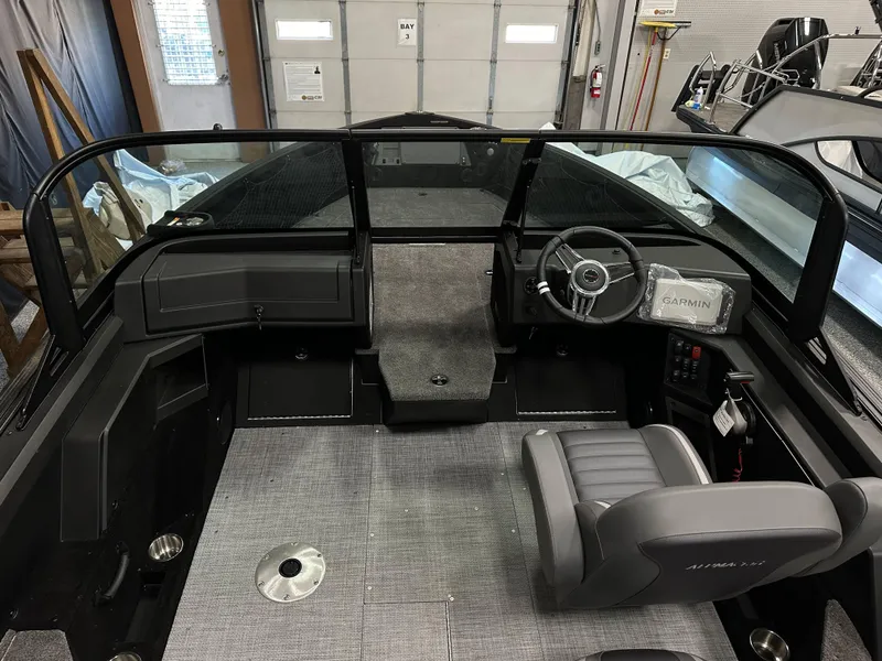 Slide: The Image of 2025 Alumacraft Competitor 175X Sport boat interior with steering wheel and Garmin device. - 12