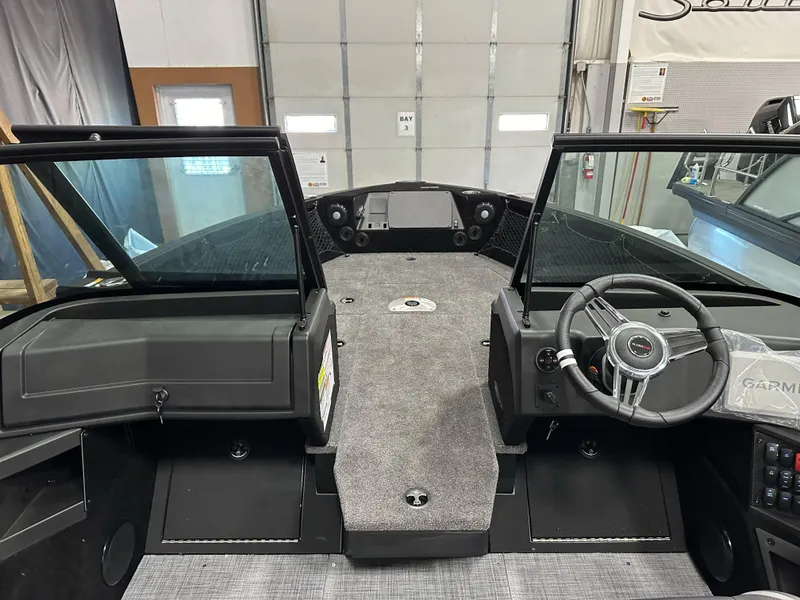 Slide: The Image of 2025 Alumacraft Competitor 175X Sport interior with steering wheel and dashboard in a garage setting. - 21